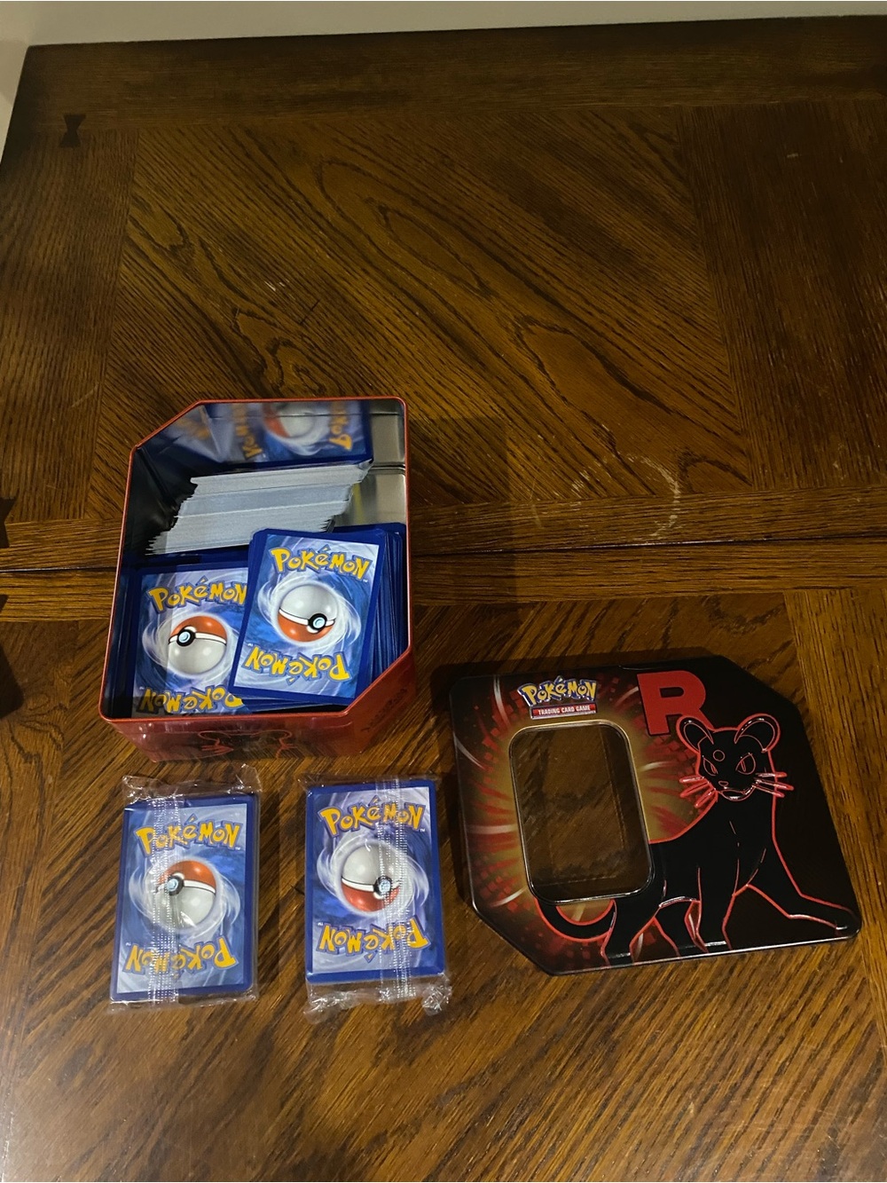 Pokemon tin of energy cards including two sealed packs.